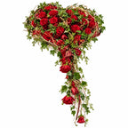 Rouwhart met rode rozen, klimop en afhangende bloemen op witte achtergrond